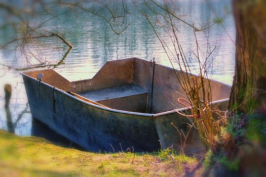 Fishing boat, aluminum rowing boat on a lake.