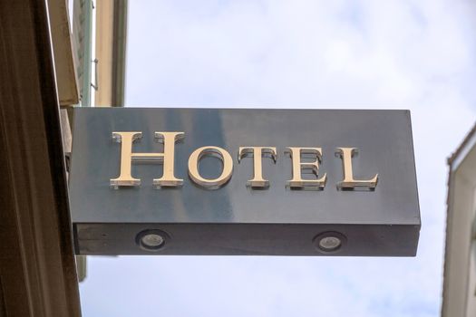 Hotel sign, metal letters, blue sky