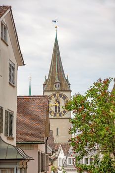 Zurich, Switzerland - June 10, 2017: Church Saint Peter, view through houses in downtown Zurich-