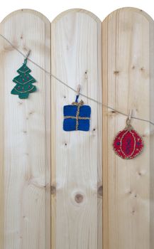 Several crocheted christmas hangers on a cord on wood, background