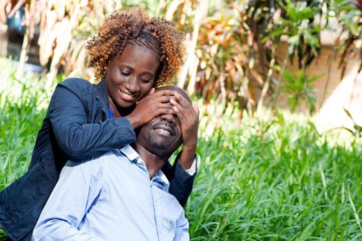 young woman played the guessing game with her lover in him closing his eyes