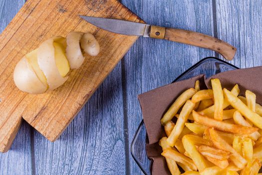 Potato peeled and cutted by hand with knife and french fries