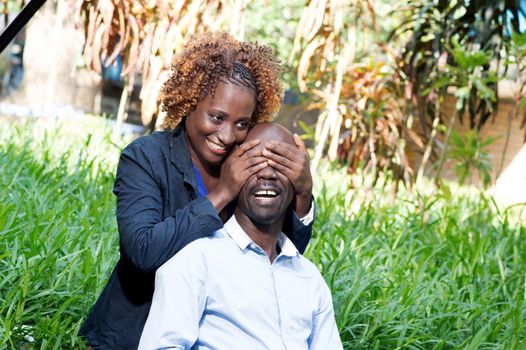young woman played the guessing game with her lover in closing his eyes.