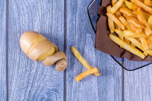 Potato peeled and cutted by hand with knife and french fries