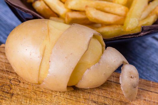 Potato peeled and cutted by hand with knife and french fries