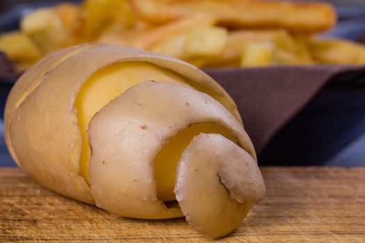 Potato peeled and cutted by hand with knife and french fries