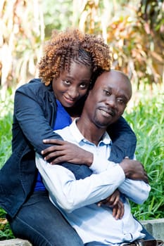 The embracing  couple sitting in a park, communicates perfect union.