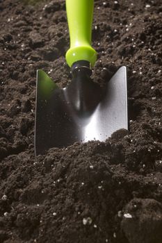 New garden tool in the soil close-up