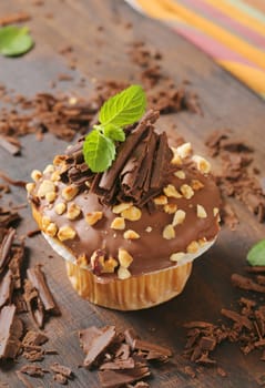 Muffin topped with chocolate and nuts