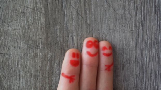 happy fingers.beautiful faces painted on the toes.