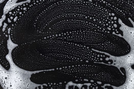 Abstract background, soapy foam texture on black