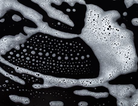 Abstract background, soapy foam texture on black