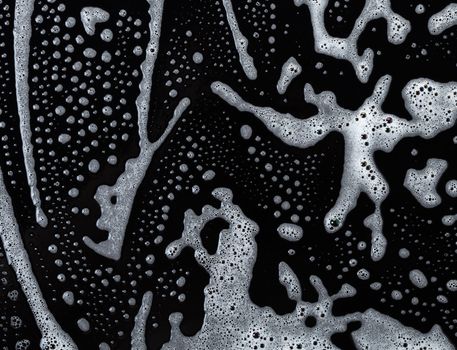 Abstract background, soapy foam texture on black
