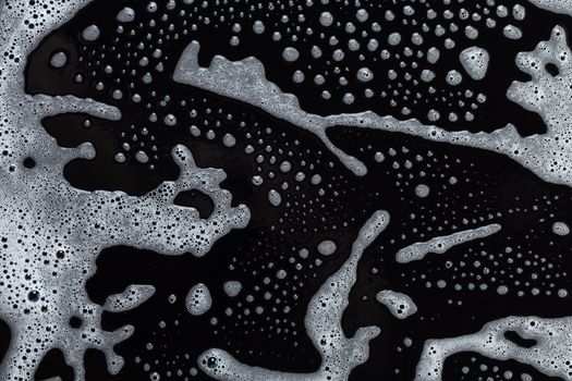 Abstract background, soapy foam texture on black