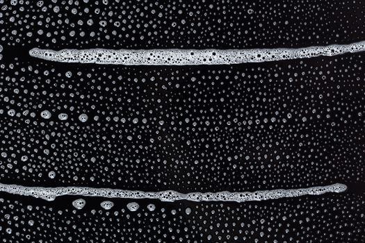 Abstract background, soapy foam texture on black