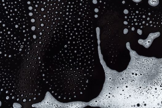 Abstract background, soapy foam texture on black
