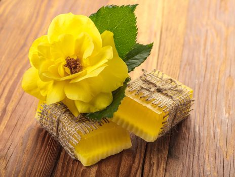 Yellow floral handmade soap on a wooden background