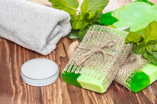 Green mint handmade soap on a wooden background