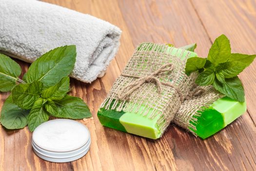 Green mint handmade soap on a wooden background
