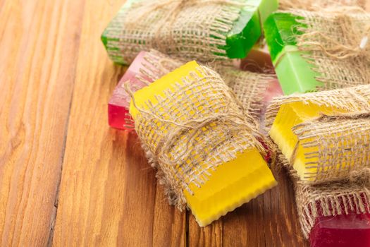 Colored handmade soap in a vintage packaging on wooden background