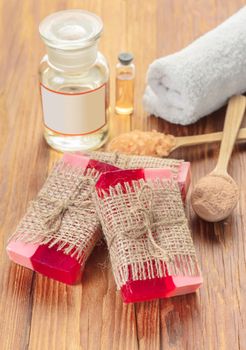 Red handmade fruit soap on a wooden background