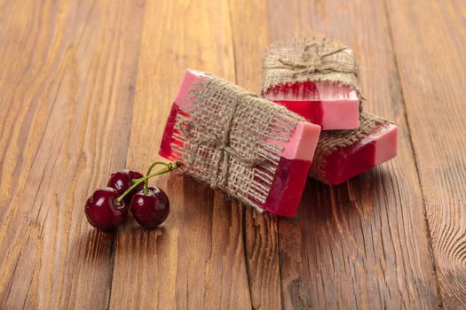 Handmade soap red cherry on a wooden background