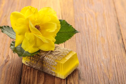 Yellow floral handmade soap on a wooden background