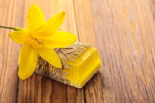Yellow floral handmade soap on a wooden background
