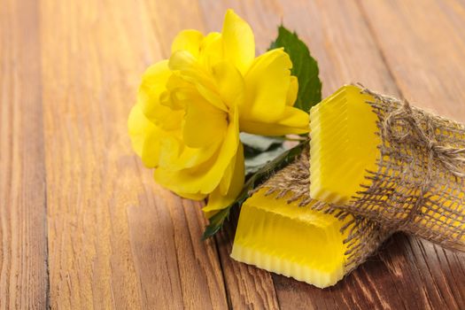 Yellow floral handmade soap on a wooden background