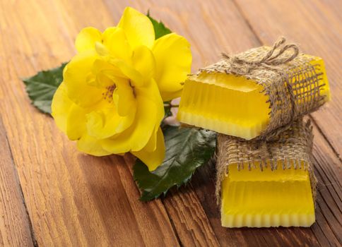 Yellow floral handmade soap on a wooden background
