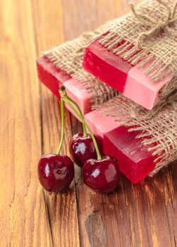 Handmade soap red cherry on a wooden background