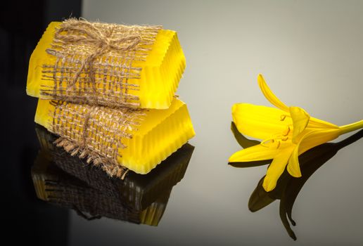 handmade soap with yellow lily on a black background