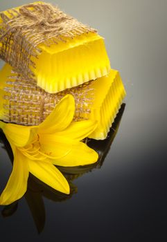 handmade soap with yellow lily on a black background