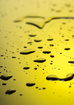 Abstract background, water droplets on black-and-yellow plastic