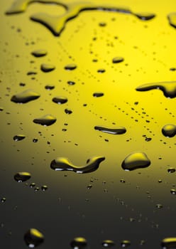 Abstract background, water droplets on black-and-yellow plastic