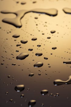 Abstract background, drops of water on a dark plastic