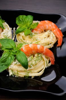 Nests of spaghetti with parmesan flavored with dill, shrimp and basil.