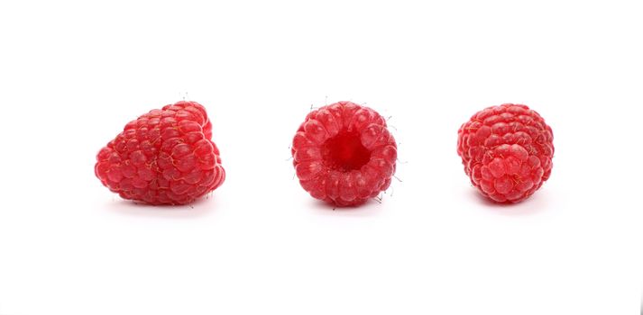 Three fresh red ripe mellow raspberry berries isolated on white background, detail close up in different perspectives, low angle view