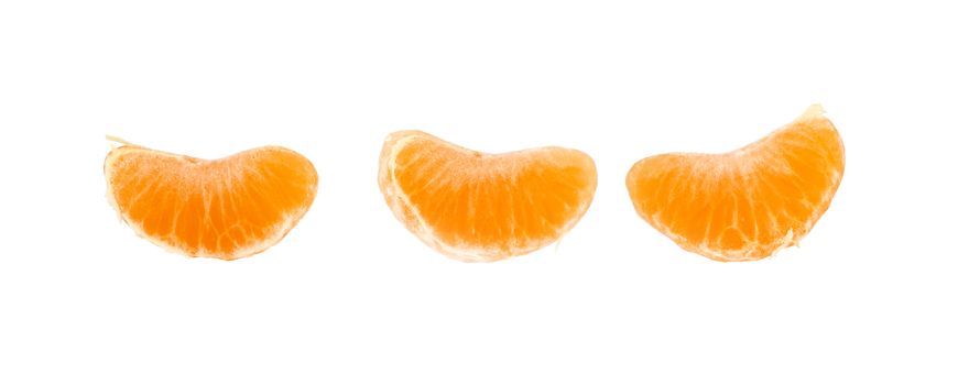 Three separate wedges segments of fresh mandarin orange isolated on white, close up, low angle view