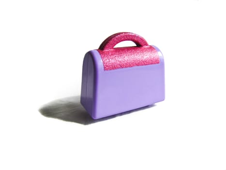 children's toy purple suitcase with sparkles isolated on white background