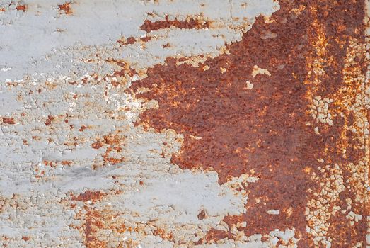 rusty iron surface covered with old chipped grey color paint, which has long been influenced by different climatic conditions