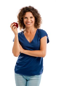 Portrait of a middle aged woman holding an apple and smiling