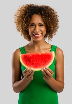 Beautiful African American woman olding a watermelon fruit on her hands