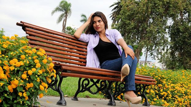 Diverse Girl And Worry Sitting On Bench