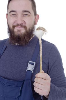 Portrait of a young bearded farmer with garlic in his hands