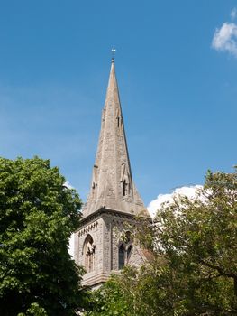 church spire top outside on clear day in country england uk