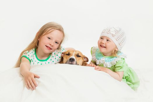 two little girls and dog on the isolated background