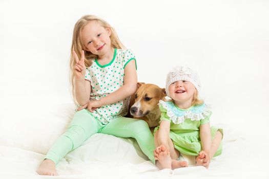 two little girls and dog on the isolated background