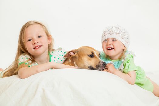 two little girls and dog on the isolated background