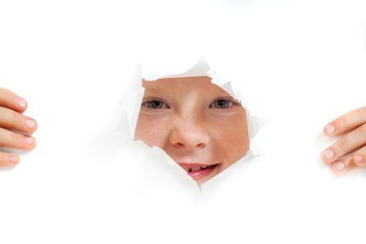 the little girl looks out through a hole in paper